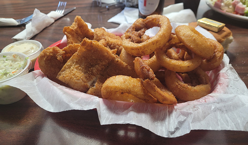 Fried fish dinner with fries and cole slaw